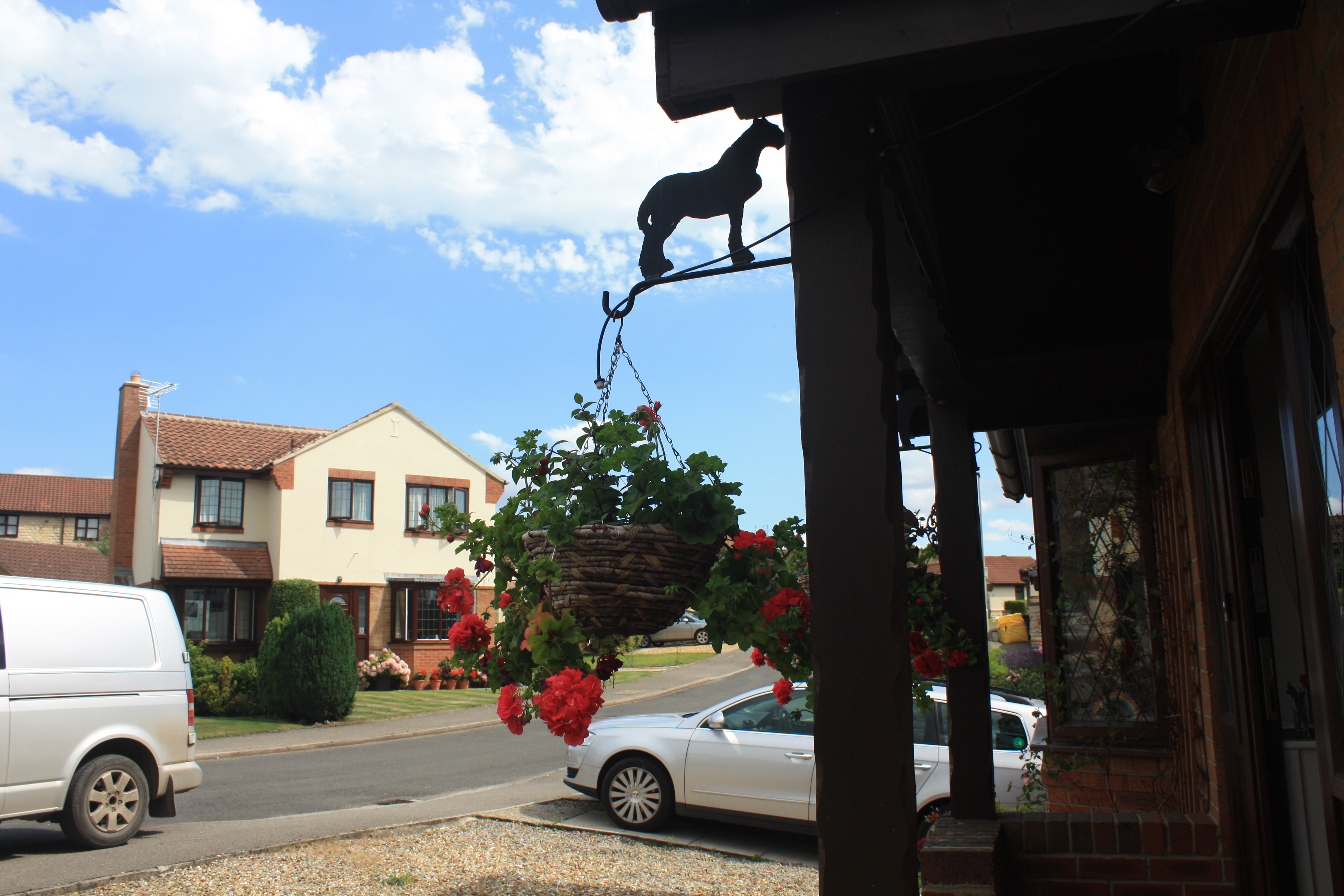Hanging basket bracket with dog silhouette